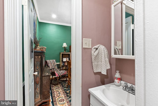bathroom with crown molding and vanity