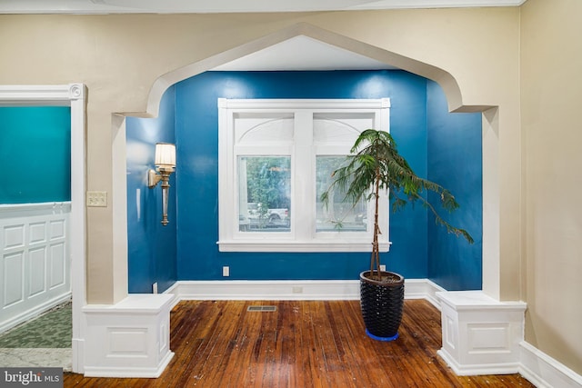 interior details featuring baseboards, visible vents, and wood finished floors