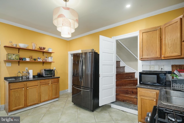 kitchen featuring range with electric cooktop, freestanding refrigerator, black microwave, light tile patterned floors, and ornamental molding