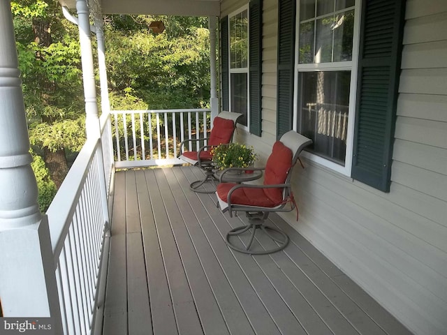 wooden terrace featuring covered porch