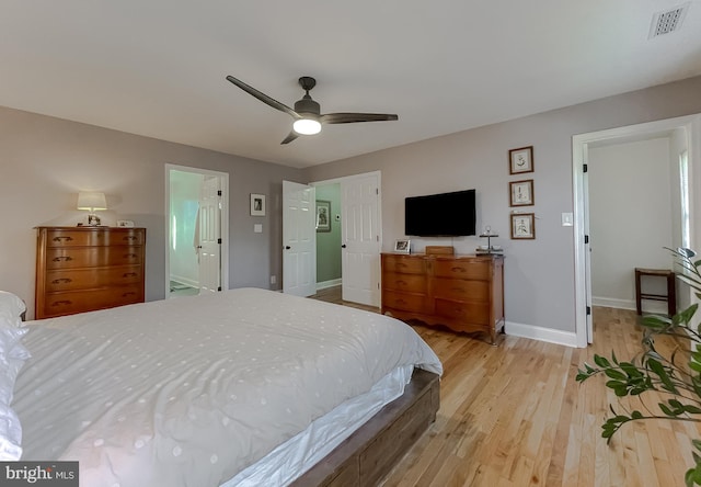 bedroom featuring visible vents, baseboards, ceiling fan, and light wood finished floors