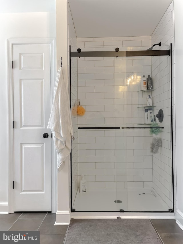 full bathroom featuring tile patterned floors and a stall shower