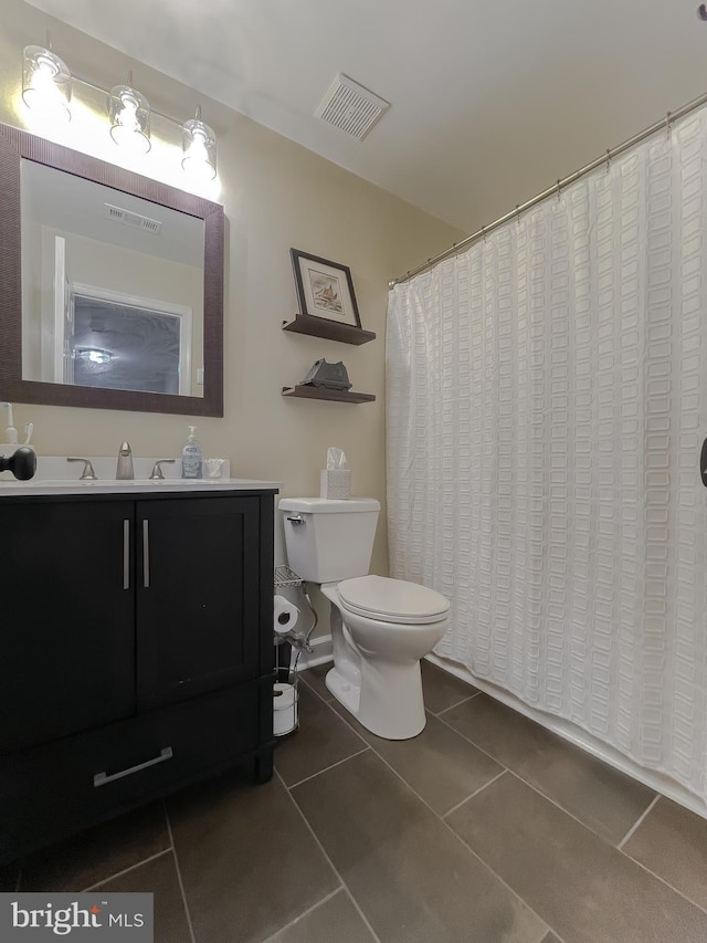 full bathroom with vanity, visible vents, curtained shower, tile patterned floors, and toilet