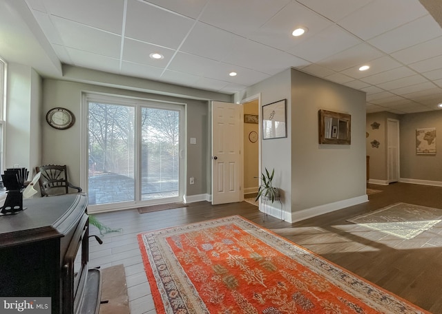 office area featuring recessed lighting, a drop ceiling, baseboards, and dark wood-style flooring