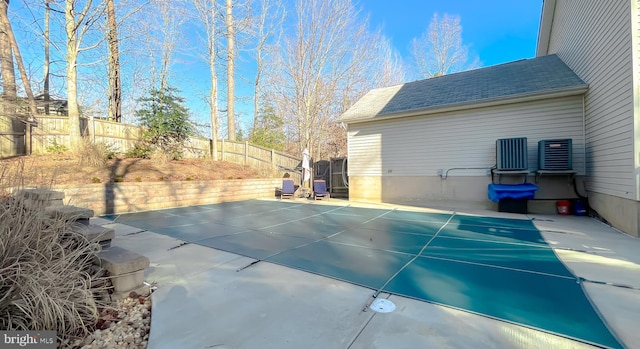 view of swimming pool featuring a patio area and fence