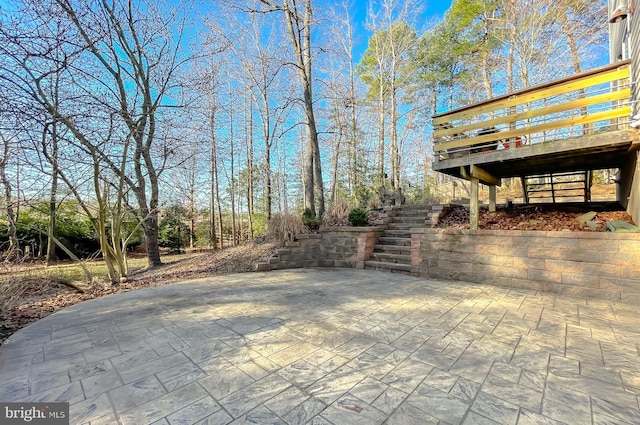 view of patio featuring stairs and a deck