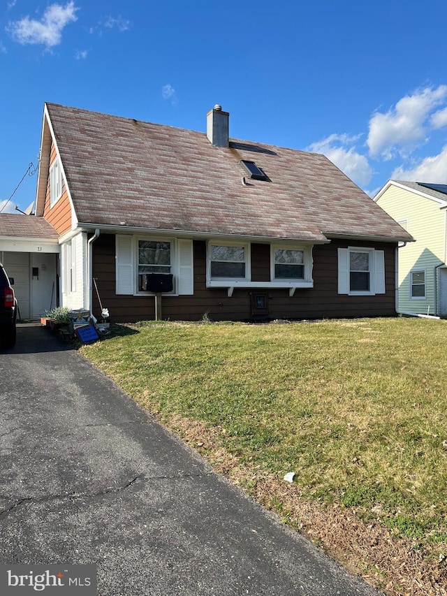 view of front of property featuring a shingled roof, a chimney, a front lawn, and cooling unit