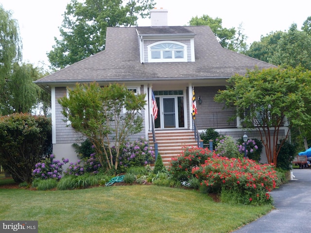 4873 Anchors Way, Galesville, MD 20765 - view of front facade featuring a front lawn, roof with shingles, a chimney, and entry steps