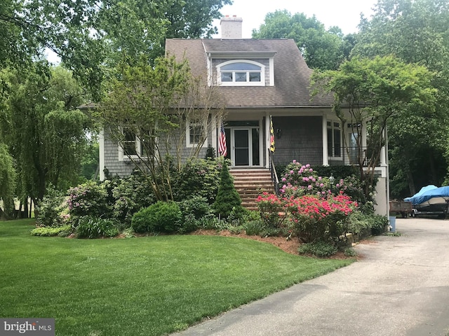 4873 Anchors Way, Galesville, MD 20765 - view of front of house with a front lawn, a chimney, a shingled roof, and a porch