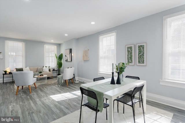 dining room featuring recessed lighting, baseboards, and light wood finished floors