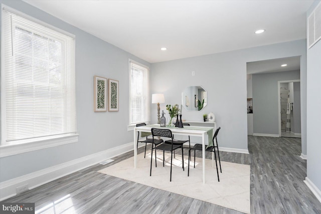 dining room featuring wood finished floors, recessed lighting, baseboards, and visible vents