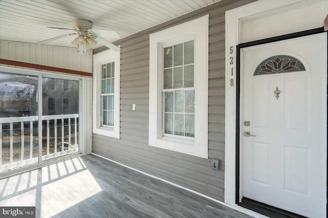 unfurnished sunroom with a ceiling fan