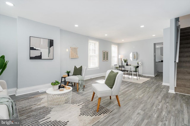 living area with recessed lighting, stairway, and light wood-style floors