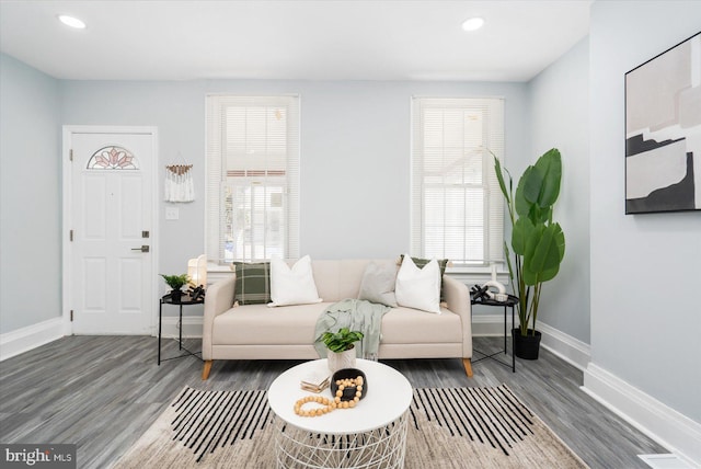 living area with recessed lighting, baseboards, and wood finished floors