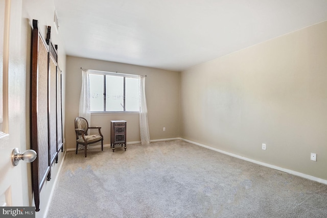 sitting room with carpet and baseboards