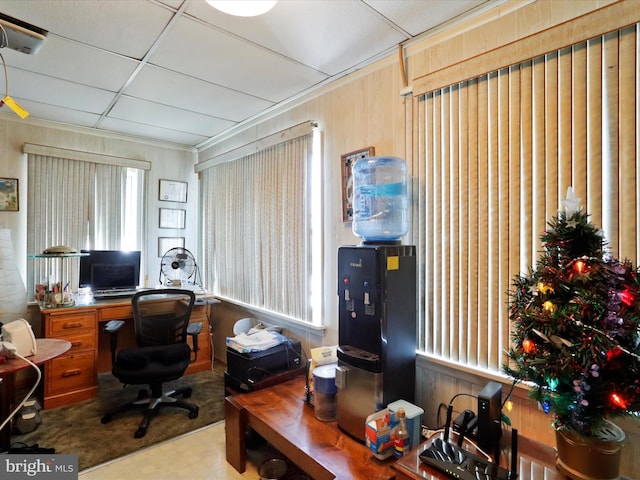 office with wooden walls and a drop ceiling