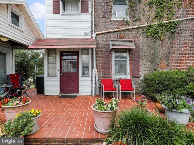 property entrance featuring brick siding