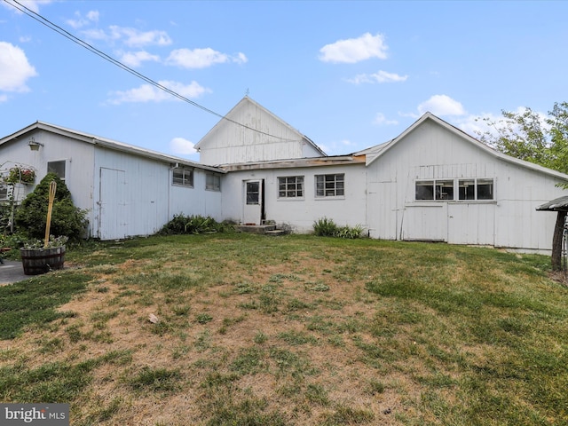 rear view of property featuring a yard