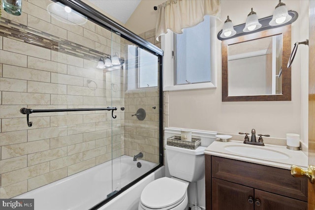 bathroom featuring shower / bath combination with glass door, vanity, and toilet