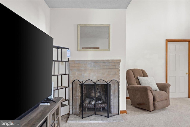 living area featuring carpet and a fireplace