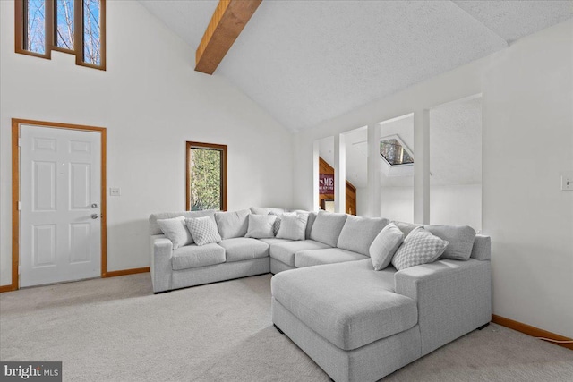 carpeted living area with high vaulted ceiling, baseboards, and beamed ceiling