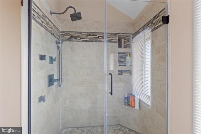 full bath with vaulted ceiling and a shower stall