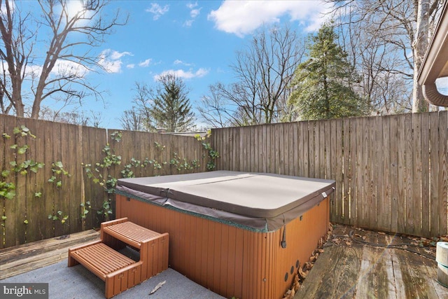 exterior space featuring a fenced backyard and a hot tub