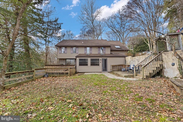 rear view of property featuring a patio area and fence