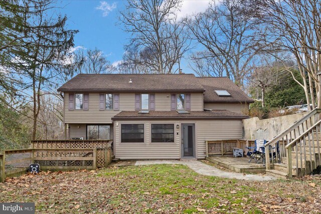 rear view of property with a deck