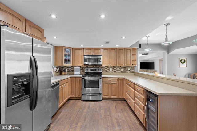 kitchen with beverage cooler, appliances with stainless steel finishes, light countertops, and decorative backsplash