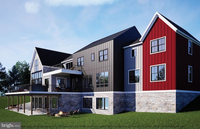 back of house with a balcony, board and batten siding, a lawn, and a patio