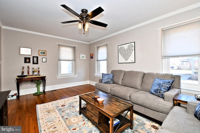 living area featuring a ceiling fan, crown molding, baseboards, and wood finished floors