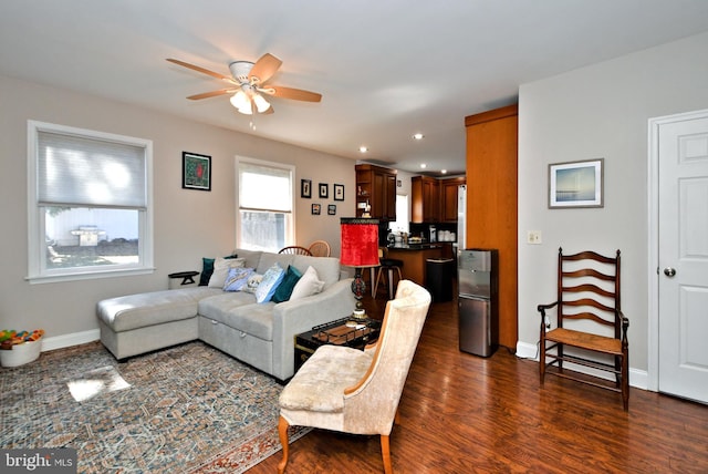 living area with dark wood-style floors, recessed lighting, a ceiling fan, and baseboards