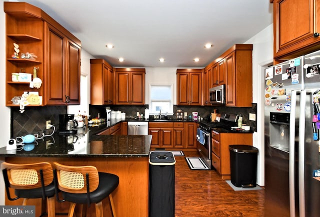 kitchen with open shelves, tasteful backsplash, appliances with stainless steel finishes, dark wood-type flooring, and a peninsula