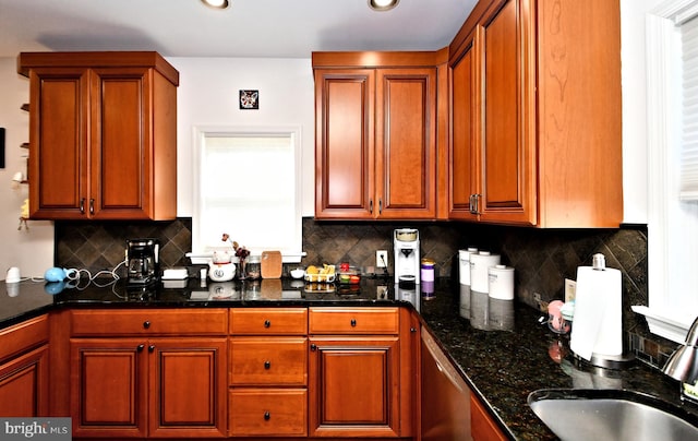 kitchen with brown cabinetry, recessed lighting, a sink, and decorative backsplash