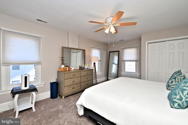 bedroom featuring baseboards, visible vents, a ceiling fan, carpet flooring, and a closet