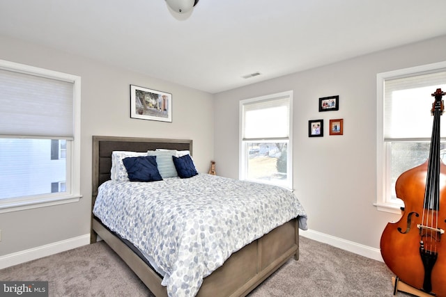 bedroom with light carpet, baseboards, and visible vents