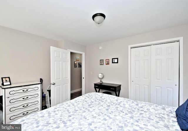 bedroom with a closet and baseboards