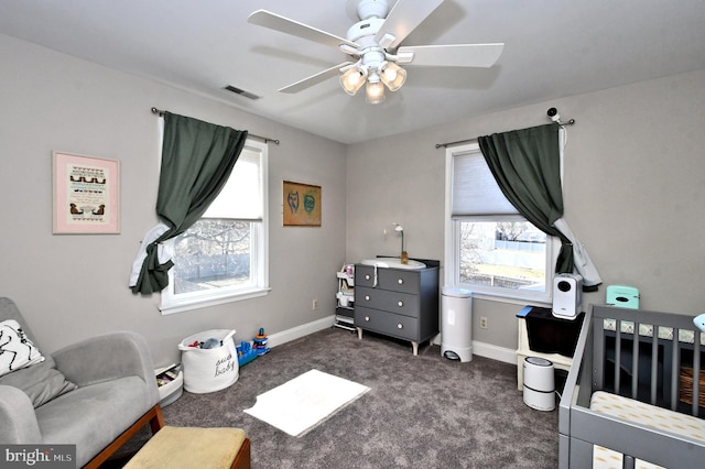 bedroom with ceiling fan, visible vents, baseboards, and dark colored carpet