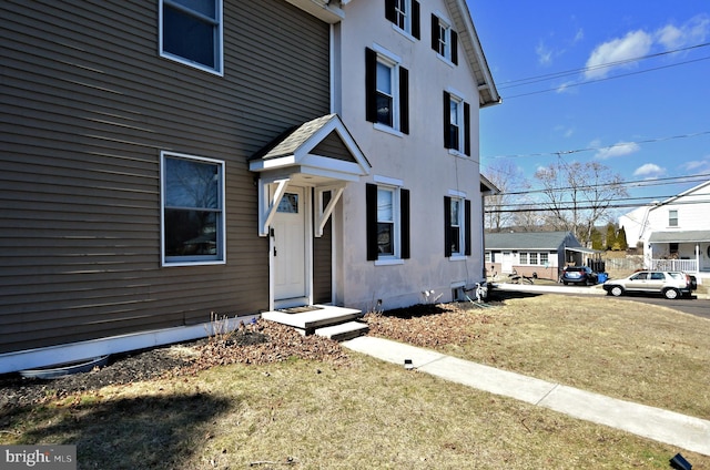 entrance to property featuring stucco siding