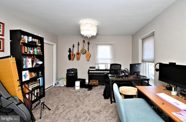 carpeted office space with a chandelier