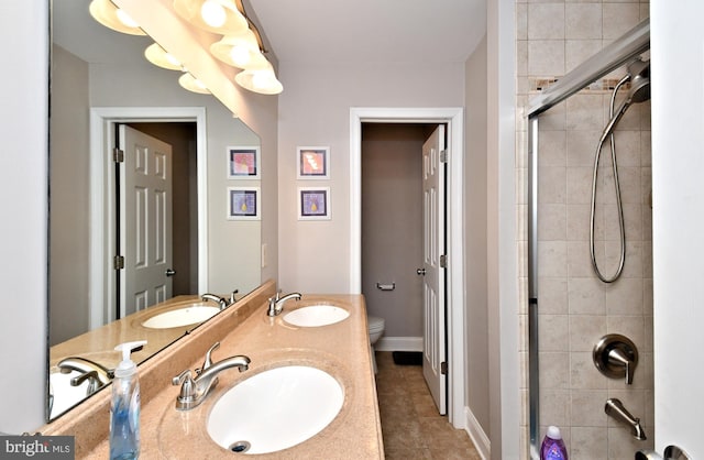 bathroom with a tile shower and a sink