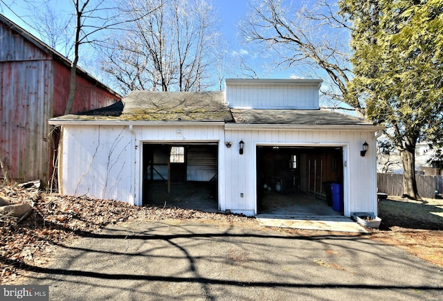 garage with driveway and fence