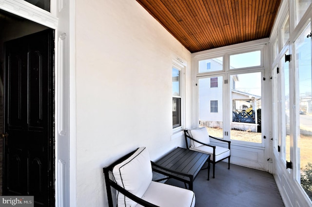 sunroom / solarium featuring plenty of natural light and wood ceiling