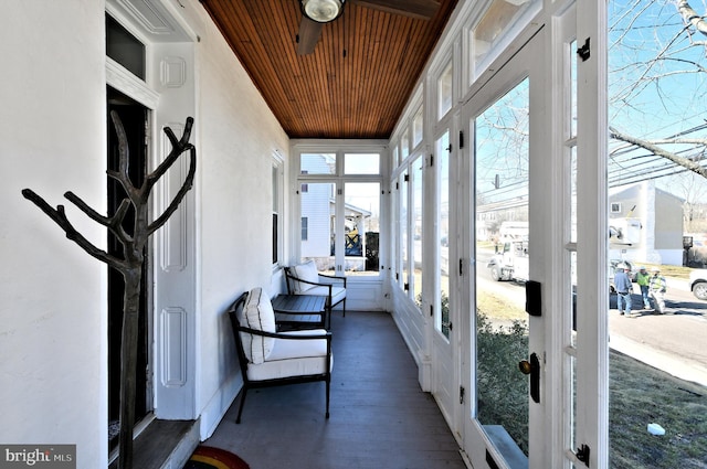 sunroom / solarium featuring wood ceiling