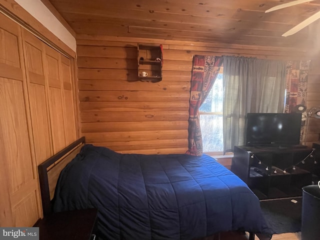 bedroom with wood walls and wooden ceiling