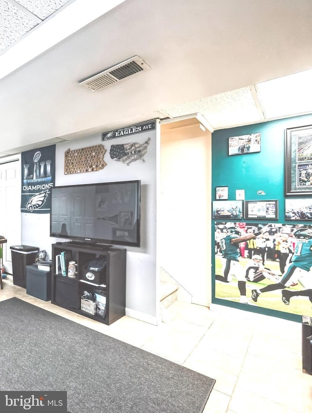 interior space featuring tile patterned flooring and visible vents