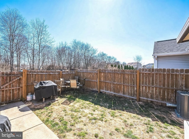 view of yard featuring central AC unit and a fenced backyard