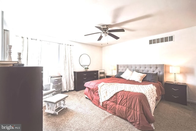 carpeted bedroom with visible vents and a ceiling fan