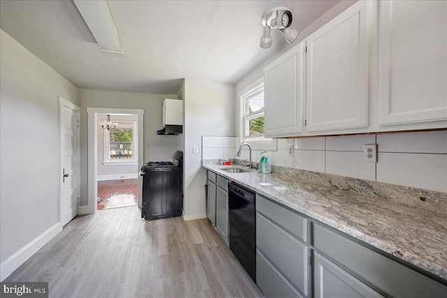 kitchen with a sink, light wood-style floors, a wealth of natural light, dishwasher, and gas range oven